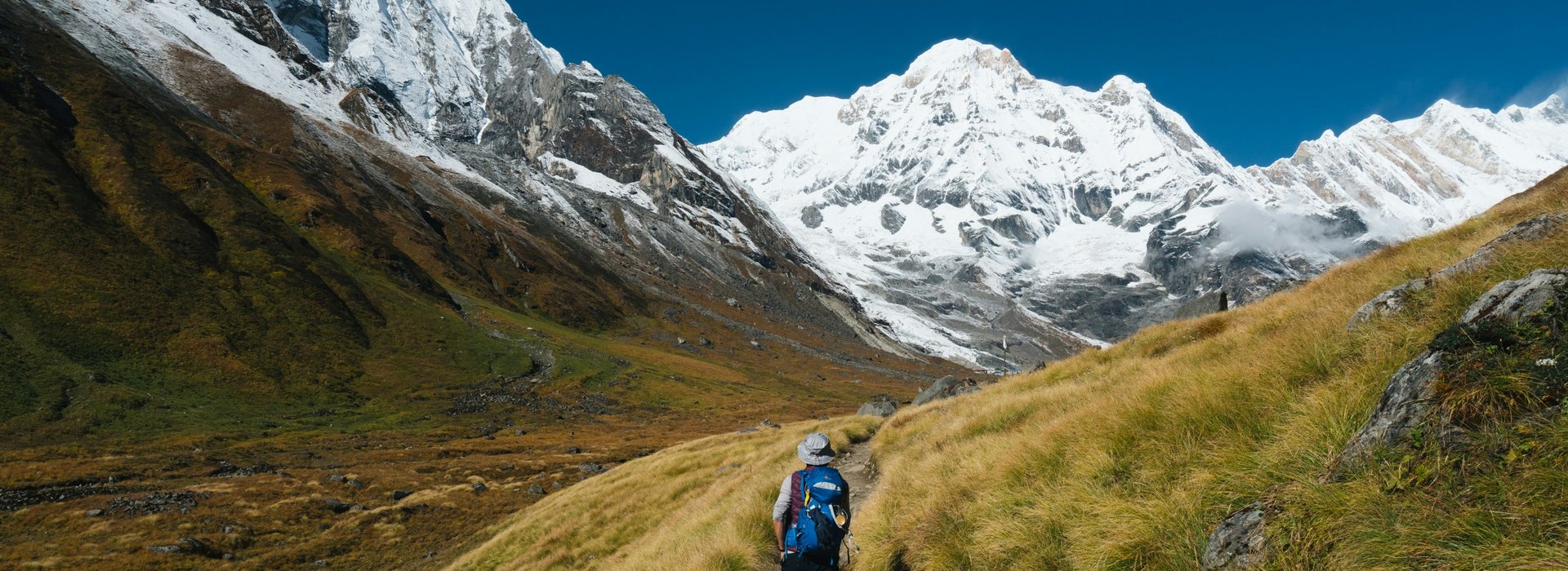 "Panoramic-view-of-Annapurna-Circuit-Trek-trail-with-snow-capped-Himalayas-and-trekkers in Nepal."