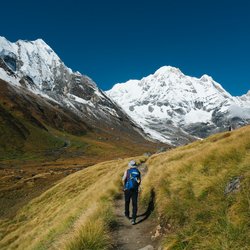"Panoramic-view-of-Annapurna-Circuit-Trek-trail-with-snow-capped-Himalayas-and-trekkers in Nepal."
