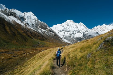 "Panoramic-view-of-Annapurna-Circuit-Trek-trail-with-snow-capped-Himalayas-and-trekkers in Nepal."