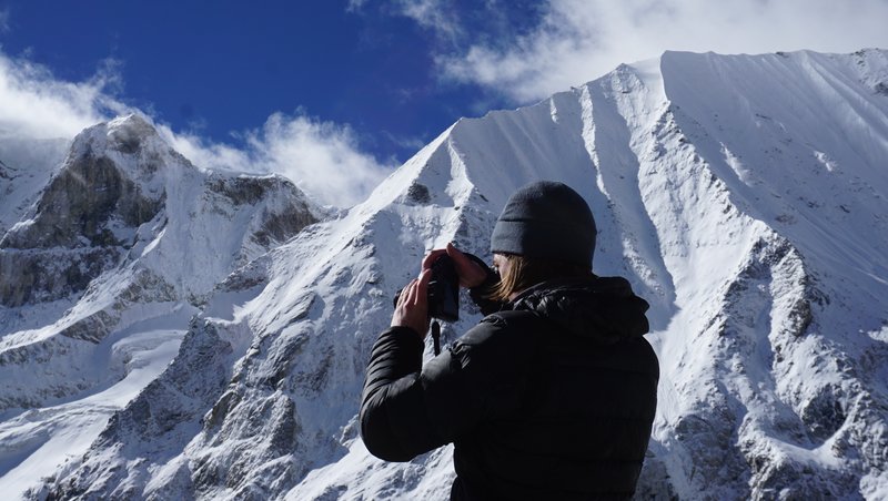 "Mist-covered valleys viewed from high pass on restricted Manaslu Conservation Area trek"