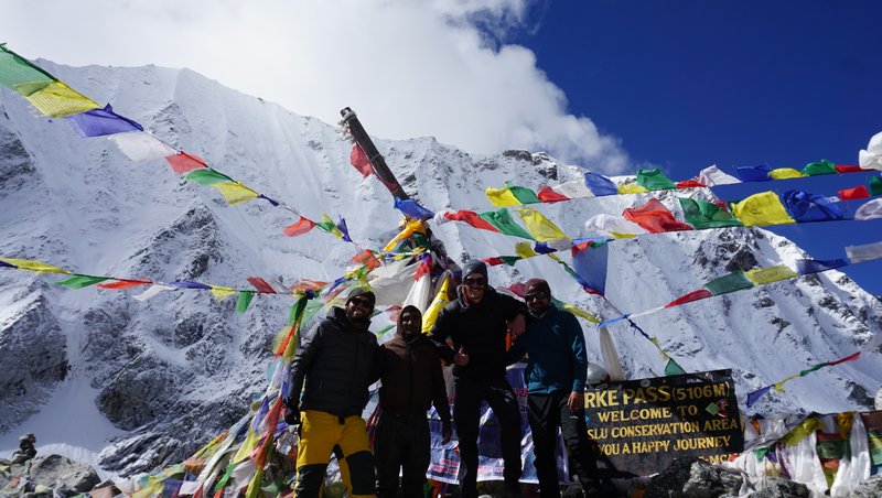"Trekkers photographing panoramic Himalayan range views from Manaslu Circuit viewpoint"
