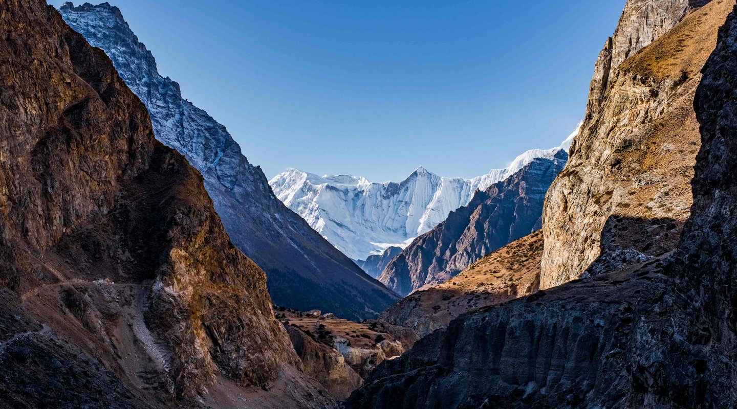 Scenic view of Nar Phu Valley with rugged rocky mountains, dramatic cliffs, and remote Himalayan landscape