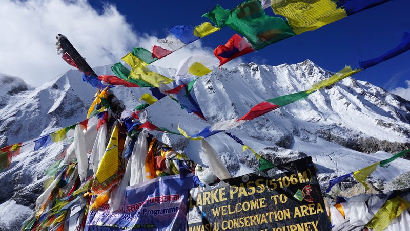 "Buddhist prayer flags fluttering at high mountain pass on restricted  The Manaslu Circuit Trek"