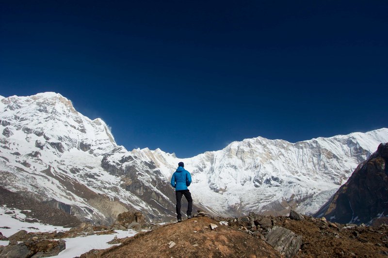 Trekker pausing on trail to enjoy the view of mount annapurna