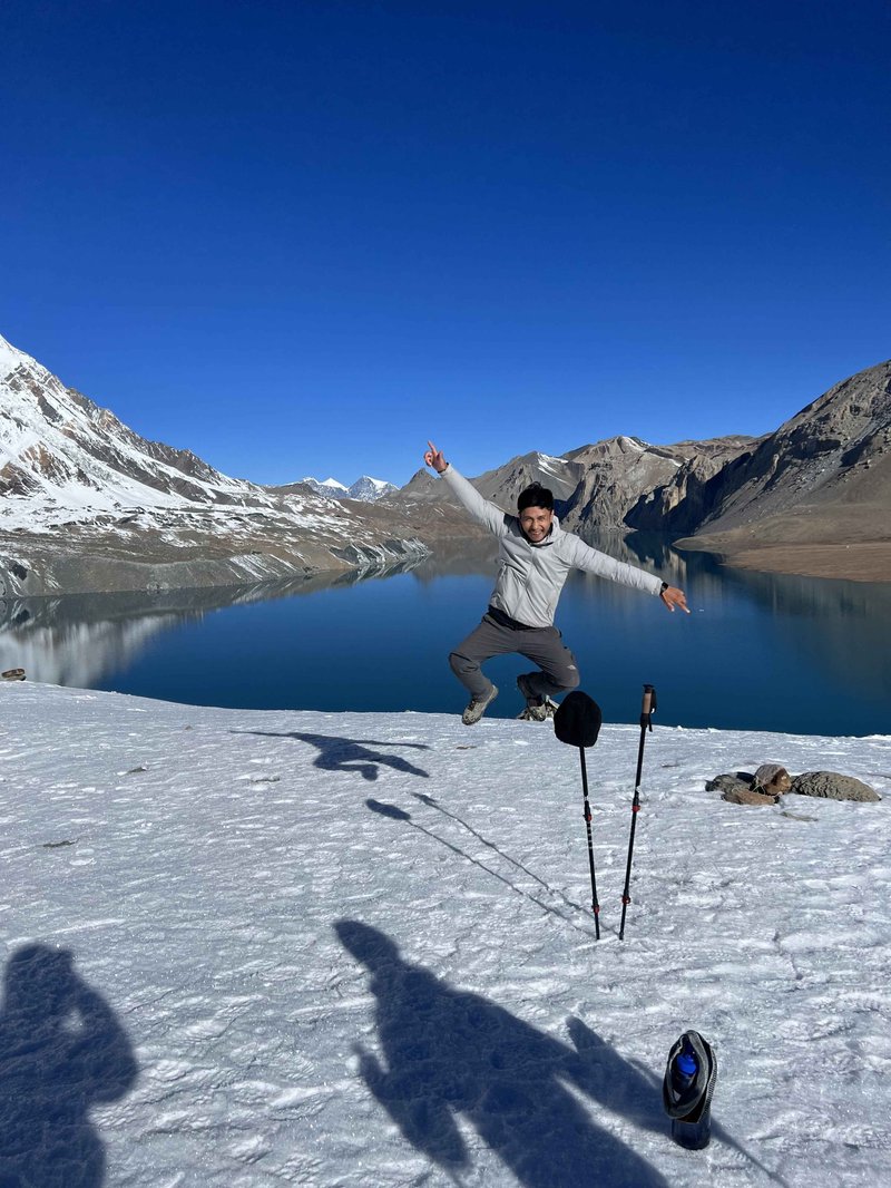 a-trekker-jumping-for-photo-in-tilicho-lake