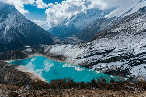 Glacial lake nestled among snow-covered peaks.