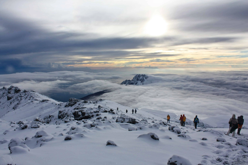 View of clouds below the summit of Mount Kilimanjaro creating a lake-like formation in the sky
