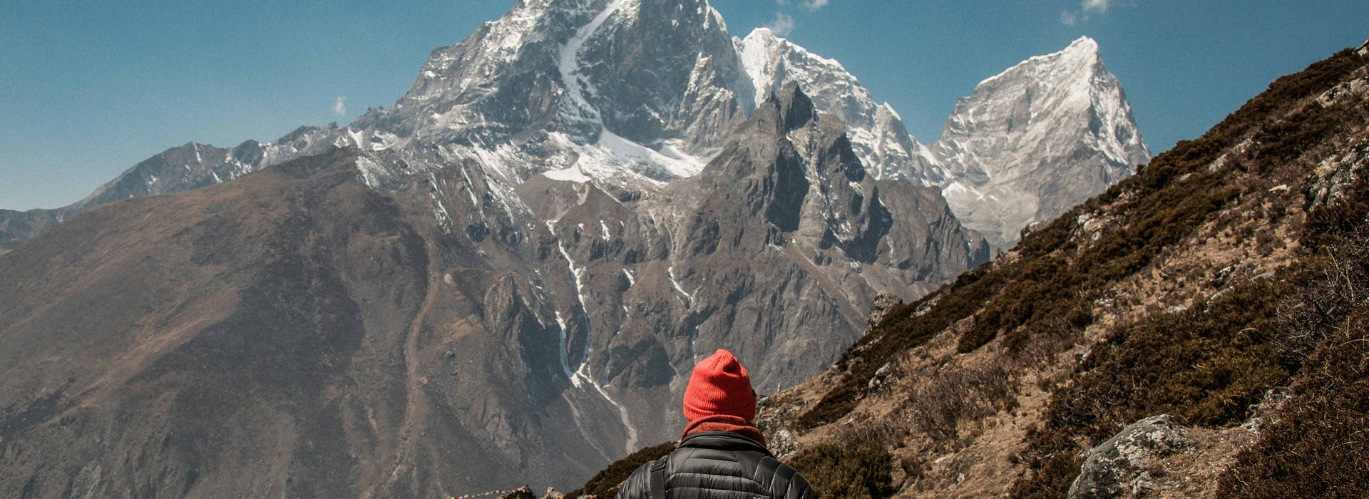 “Trekker walking on the Everest Three Pass trek trail with panoramic Himalayan mountain views in Nepal.”