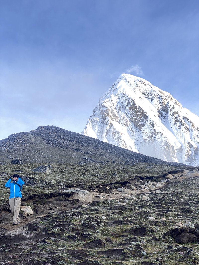 solo female adventurer hiking Everest Base Camp trail in Khumbu valley Nepal