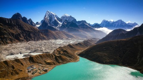 Turquoise Gokyo Lake with snow-capped Himalayan peaks and rugged valleys along the Gokyo Cho La Pass trek in Nepa