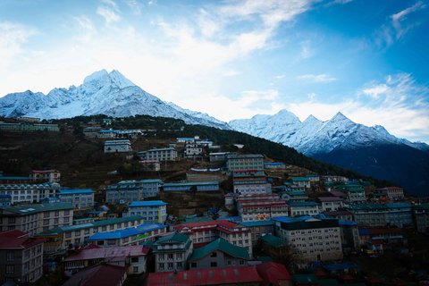 Namche Bazaar with colorful houses and lodges beneath snow-capped Himalayan peaks on the Jiri to Everest Base Camp trek route in Nepal
