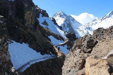 Trekking trail in the Langtang Helambu region with snow-covered mountains and a narrow high-altitude path