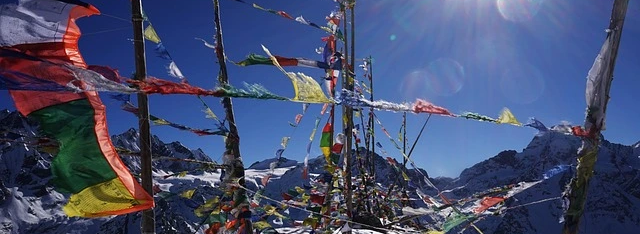 Colorful Buddhist prayer flags with snow-capped Langtang Lirung mountain in Langtang Valley, Nepal