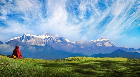 a monk enjoying the view of annapurna sanctuary