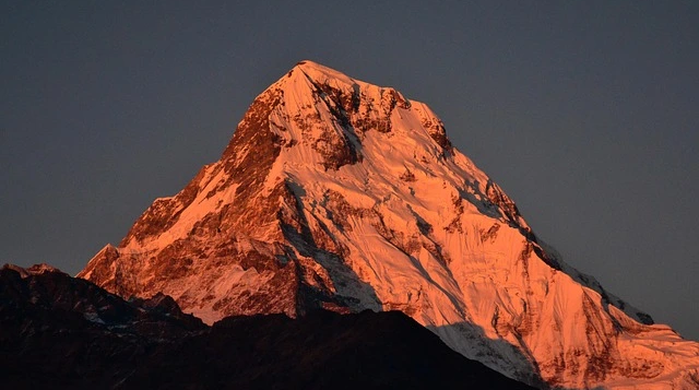 Mount Annapurna I at sunrise showing its steep snow-covered summit and rugged Himalayan terrain in Nepal