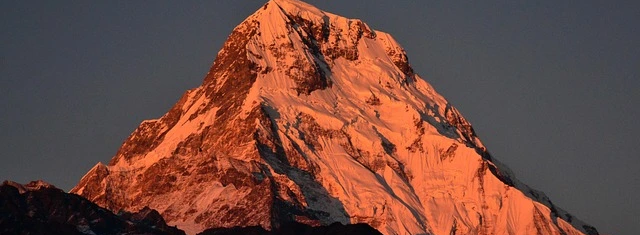 Mount Annapurna I at sunrise showing its steep snow-covered summit and rugged Himalayan terrain in Nepal
