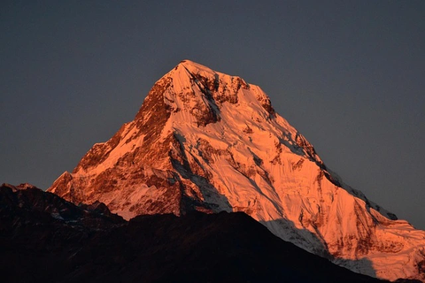 Mount Annapurna I at sunrise showing its steep snow-covered summit and rugged Himalayan terrain in Nepal