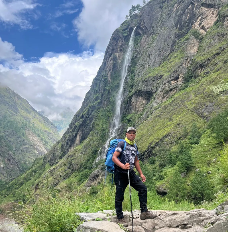 HimalayanHero guide leading trekkers through scenic landscapes on the Manaslu Tsum Valley Trek.