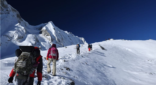 Hiker walking in the mountain with a walking stick during the Manaslu Circuit trek.