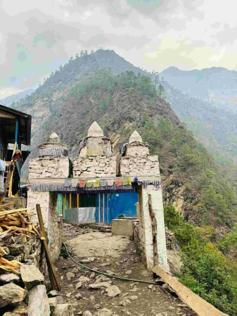 A traditional stone archway over a mountain trail during the Manaslu Circuit Trek in Nepal.