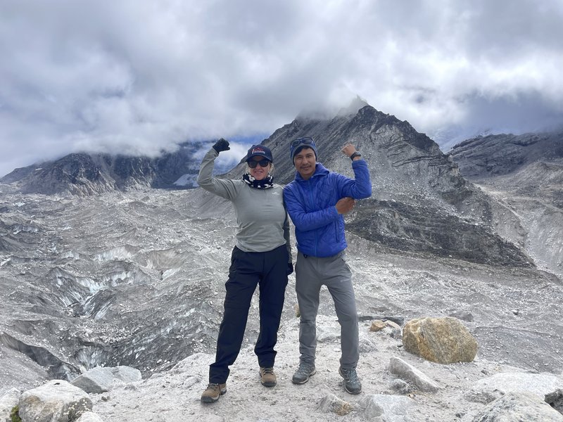 Experienced EBC trek guide with female trekker with Himalayan panorama