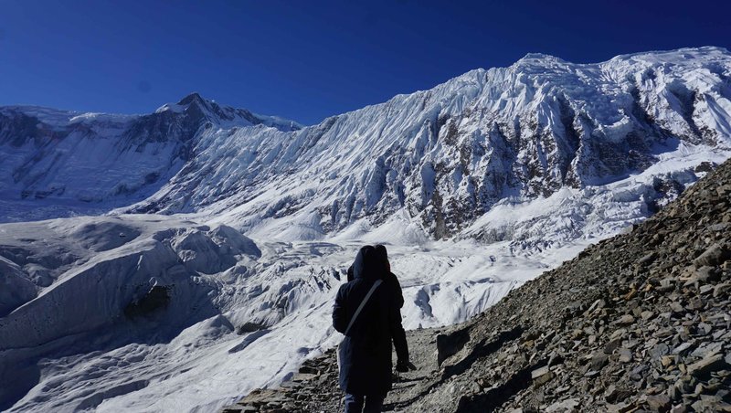 Adventure trekkers navigating the icy paths of Annapurna with panoramic mountain views