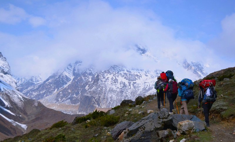 Group of hikers ascending a rocky trail with scenic vistas