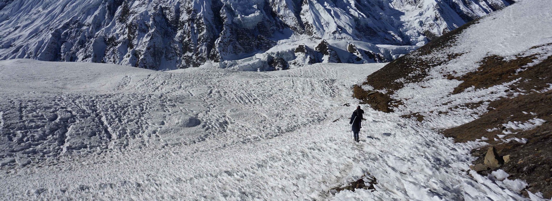 Trekkers crossing icy terrain on Annapurna Circuit trek in Nepal Himalayas during winter season